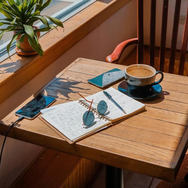 An open notebook on a table in the sunshine