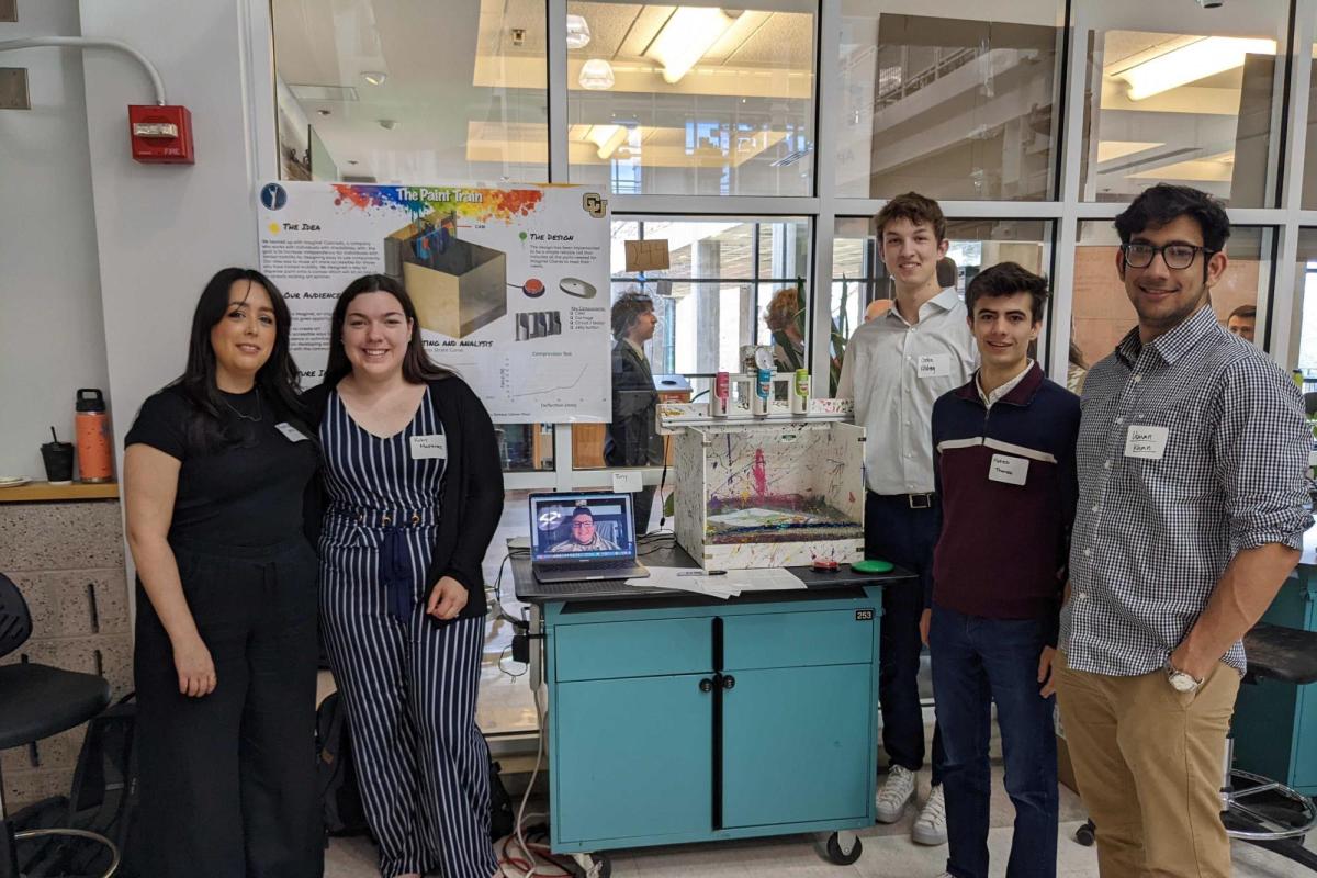 The Paint Train group stand with their project