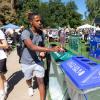 Man putting item in a recycling bin.
